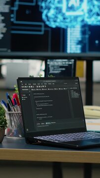 Vertical video Close up of laptop in empty office used to accelerate complex artificial intelligence calculations. Notebook program used for deep learning training datasets systems, camera B