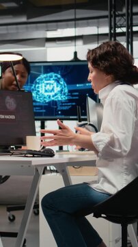 Vertical video Scared admins in office panicked by alert, trying to stop hacker intrusion stealing sensitive data. Startup coworkers doing frantic incident response to network attack from