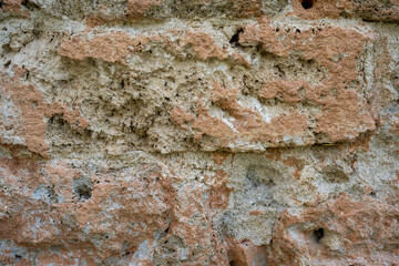 High-resolution weathered brick wall texture featuring faded red bricks, chipped surfaces, and aged mortar. Suitable for architectural references, texture mapping, and rustic background designs.