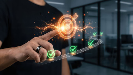 Person pointing at glowing target symbol with path of checkmarks, representing achievement and success in modern office setting. image conveys motivation and goal setting
