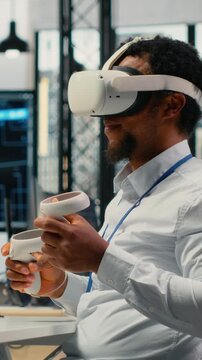 Vertical video Programmer in office using virtual reality tech to fix hacking attempt on corporate network. IT expert uses VR headset to investigate unauthorized access alerts, working to mitigate