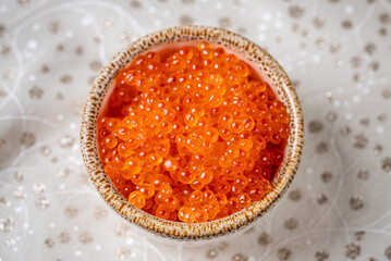 Bright red caviar in elegant holiday bowl