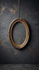 A gold framed oval hanging from a string