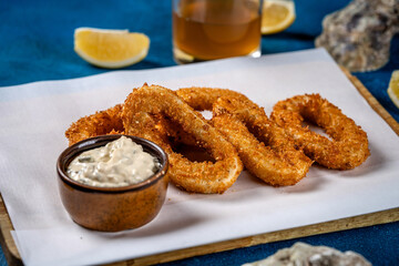 Crispy golden calamari rings with dip