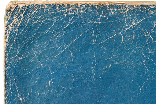 Blue cracked book cover. Close-up of vintage textured blue book cover with dramatic cracked surface. Natural background for retro design, nostalgia, creative grunge effect. Copy space