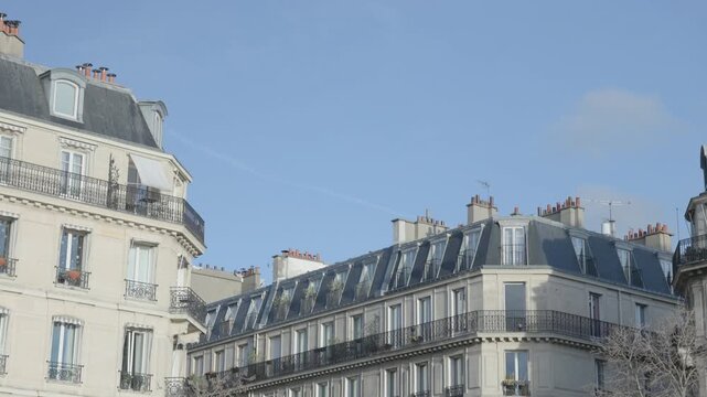 Pan Shot of Haussmannian Building Roof Against Blue Sky in Paris Franc