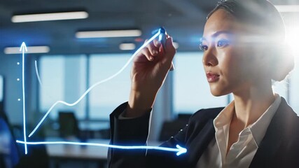 Asian woman in business attire drawing upward blue arrows on virtual board. Side view closeup in modern office showing career growth and success concept for professional development and achievement - Powered by Adobe