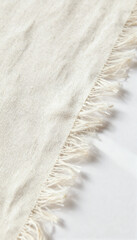 Close-up of linen fabric with frayed edge on white surface
