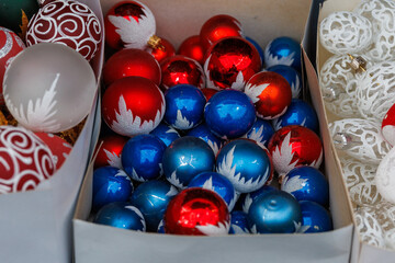 Colorful Christmas baubles with decorative patterns displayed at festive market stall