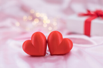 Fototapeta premium Valentines decoration with red hearts and ribbon present.