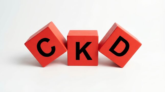 Three bright red wooden blocks arranged with letters C K and D visible set against a clean white background CKD abbreviation cubes alphabet words education learning healthcare medical