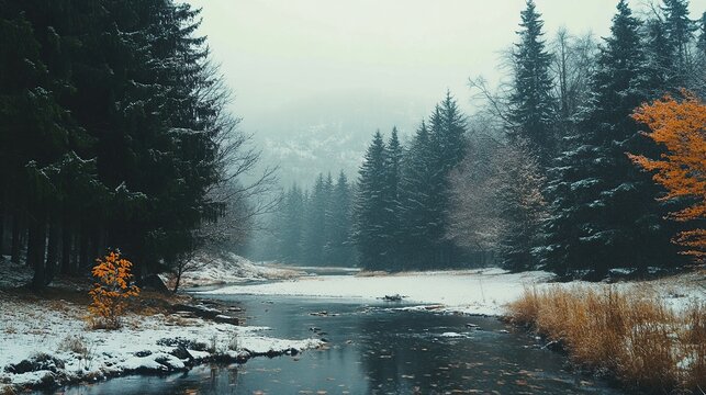 A serene winter landscape features a winding river flowing through a dense forest, partially covered in snow and autumn leaves, under a misty, overcast sky. - Powered by Adobe