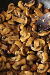 Cooking mushrooms in a frying pan. Close-up. Selective focus.