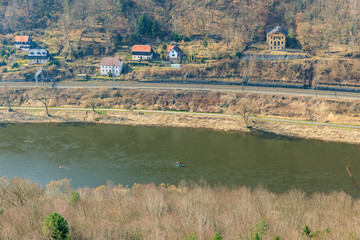 Fototapeta premium Scenic riverside view with houses and railway in serene landscape