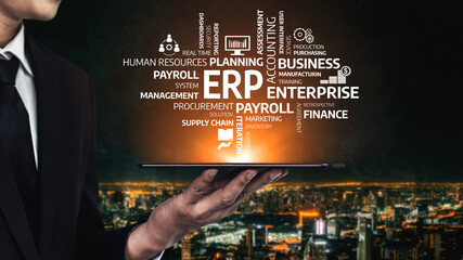 A business professional presents a tablet showcasing key ERP concepts against a stunning cityscape backdrop. This image reflects modern enterprise management and technology integration. Tessel