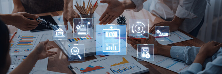A professional business team collaborates on tax strategy in a modern office, utilizing digital icons that represent various aspects of finance and economic growth. Trope