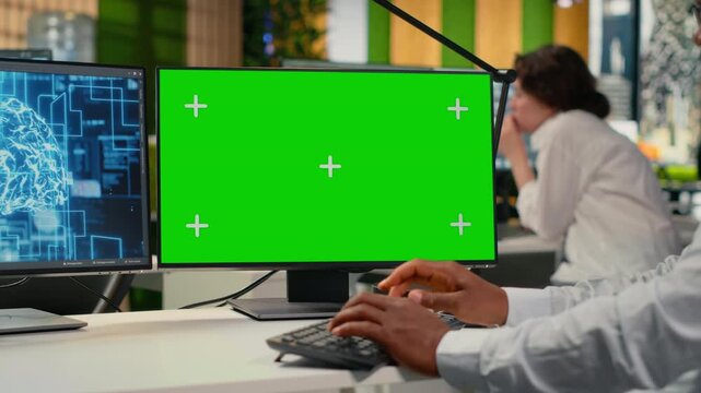 Green screen mockup PC used by data scientist in office automating workflows with artificial intelligence. IT worker refines deep learning models on chroma key computer for faster processing, camera B