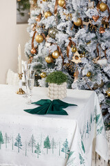 Christmas tree with green centerpiece on forest print tablecloth