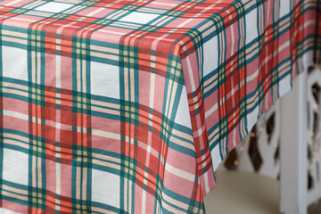 Closeup of red green plaid Christmas tablecloth