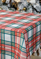 Red green plaid Christmas tablecloth on dining table
