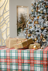 Festive plaid tablecloth with gifts and Christmas tree