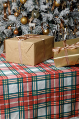 Single craft gift box on plaid Christmas tablecloth