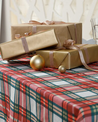 Wrapped gift boxes on red green plaid Christmas table