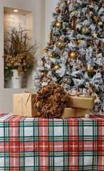 Christmas tree with gifts on plaid holiday tablecloth