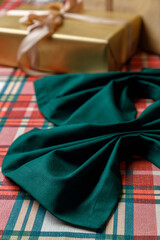 Corner of green table runner on plaid holiday table