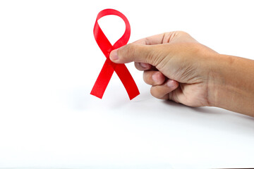 Hands holding a Red Ribbon for World AIDS Day in December isolated on white background. Health concept against AIDS disease.