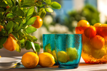 Bright Summer Day with Fresh Citrus Fruits and Textured Blue Glasses