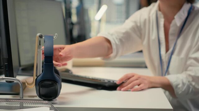Programmer in office listening music, automating workflows using artificial intelligence technology. Woman wearing audio headphones refining deep learning computational models, camera B