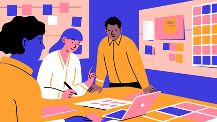 Creative designers and marketers reviewing layouts in studio