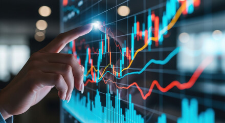Close up of woman analyzing financial market data charts on a screen with blue and orange lines, showcasing stock market trends and investments.