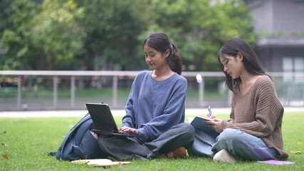 Two asian female students sitting on stairs using laptop for study or project at university, concept of modern education, remote learning, teamwork, digital study and student collaboration knowledge - Powered by Adobe