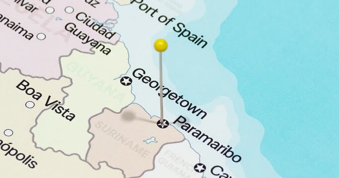A zoom out of a yellow pin into Paramaribo city of Suriname political map