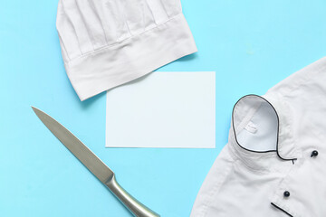 Blank card, knife and chef's uniform on blue background