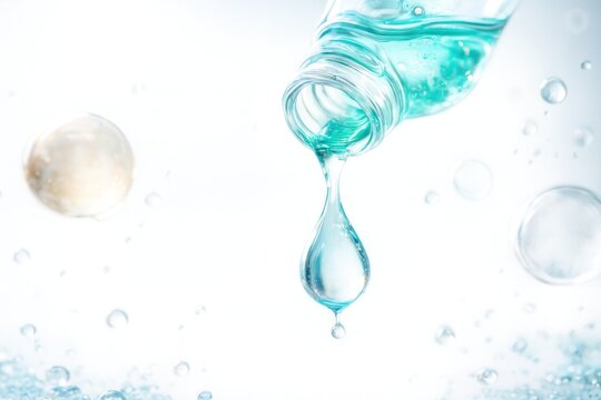 Drops of clear moisturizing liquid readily touch a clean white surface, demonstrating the natural ingredients and their benefits for skin.