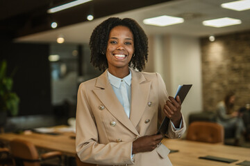 African american businesswoman holding document folder in modern office