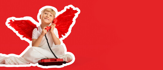 Naklejka premium Cute little happy boy dressed as cupid with retro phone sitting on red background. Valentine's Day celebration