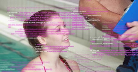 Using blue tablet, adult showing purple code to swimmer in pink swimsuit at tiled pool wall