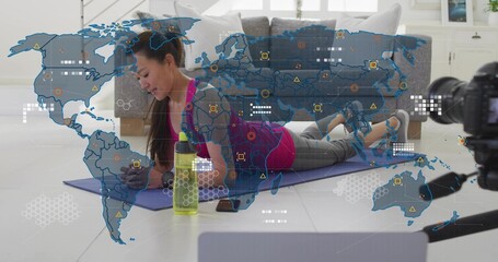 Holding forearm plank, Korean trainer in pink tank, grey leggings at home with purple mat, camera