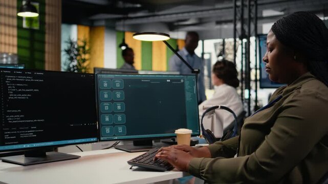Software developer in office solving tasks with AI LLM chatbot answering prompts. Tech agency system administrator using PC to interact with large language model program, camera A
