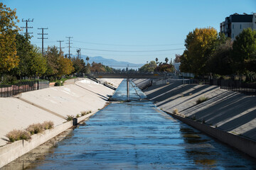 View of the Los Angeles river passing through the Canoga Park neighborhood in the San Fernando Valley area of Los Angeles California.  