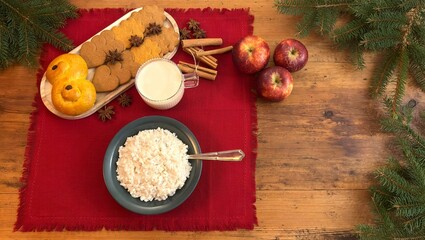 Swedish Christmas tradition with rice porridge for Santa, gingerbread cookies, apples and milk, Christmas card with copy space