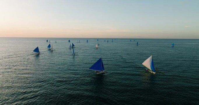 Blue sea with paraw sailing boats. Sunset viewing in Boracay, Philippines.