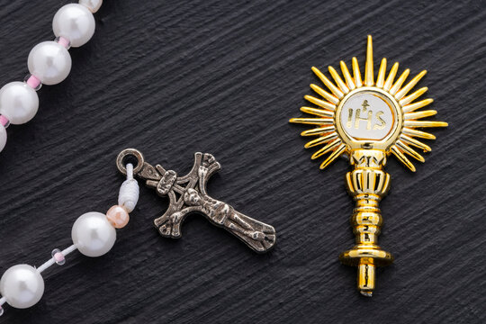 Golden brooch, Golden religious symbol with IHS monogram and Catholic rosary