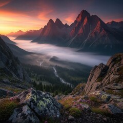 Majestic Mountain Range at Sunrise with Fog and Pink Clouds in a Natural Landscape