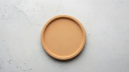 Minimalist cork tray presented on a neutral textured surface overhead view