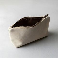 Open neutral-toned pouch featuring a visible zipper on a simple surface